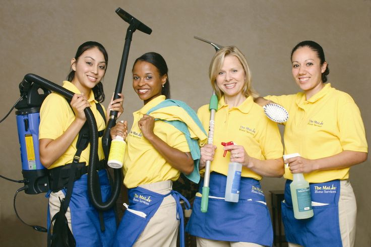 Professional house cleaning team in uniform with equipment